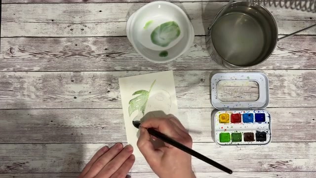 Application du lavis vert-bleu sur la feuille en contournant les trous, avec granulations et fusions visibles sur le papier