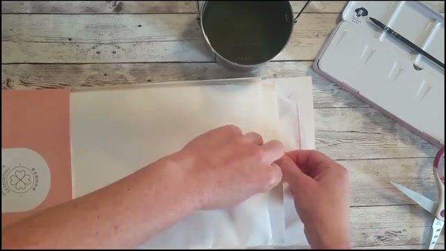 Découverte du papier aquarelle pailleté, l'autrice montre la finition brillante inattendue du papier sous la lumière