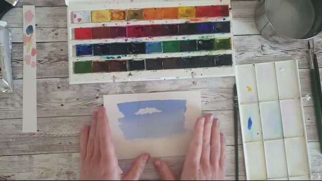 Résultat visible d'un nuage peint à la gouache blanche sur un ciel aquarellé sec, montrant le contraste entre le blanc opaque de la gouache et le bleu du ciel