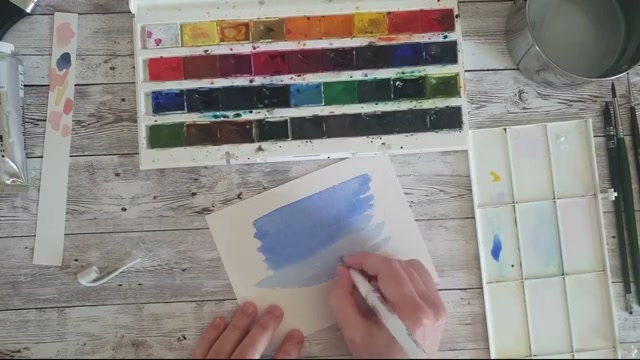 Démonstration du stylo gel blanc gratté sur la surface texturée du papier aquarelle pour créer des reflets irréguliers imitant des reflets sur l'eau
