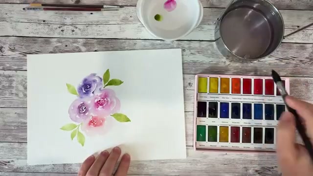 Vue d'ensemble de la peinture florale en cours de réalisation avec plusieurs couleurs testées, montrant le rendu final des pigments et la satisfaction globale du test