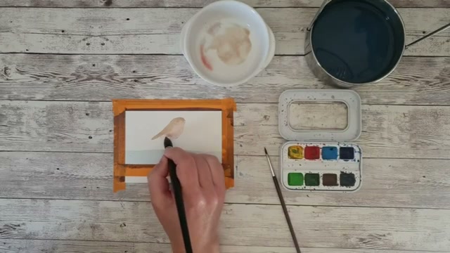 Moment de fusion visible entre le marron du dos et le rouge du ventre : les deux couleurs se touchent et se mélangent naturellement sur le papier humide