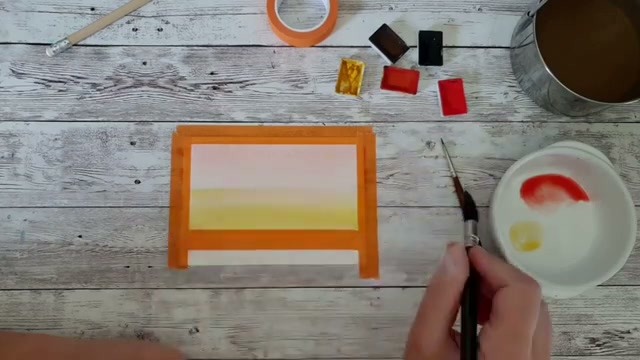 Moment où les couleurs rouge et jaune se rencontrent au milieu du papier pour créer un orangé naturel dans le dégradé aquarelle